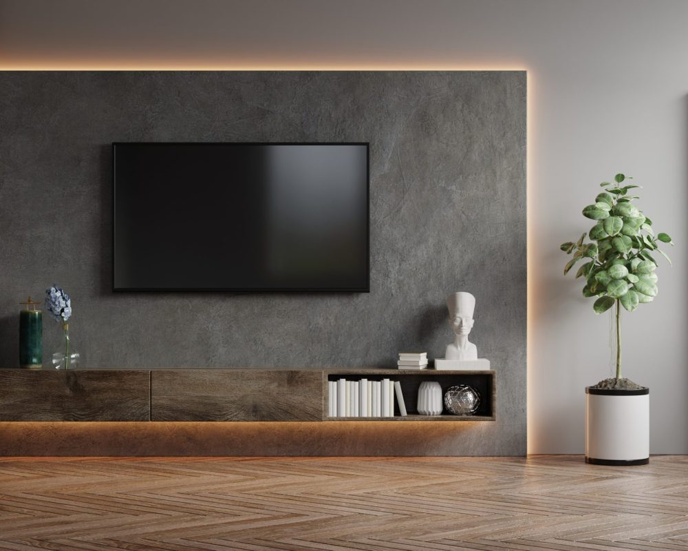 Mockup a TV wall mounted in a dark room with concrete wall.3d rendering